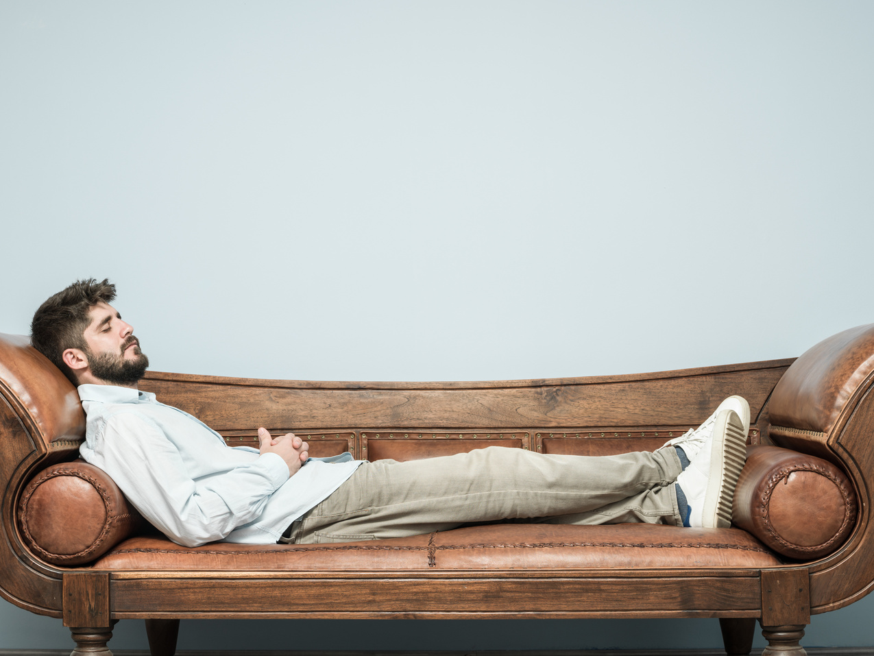 Adult Man Lying Down On Psychiatrist Couch